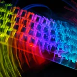 A keyboard with rainbow backlighting streaked by motion blur