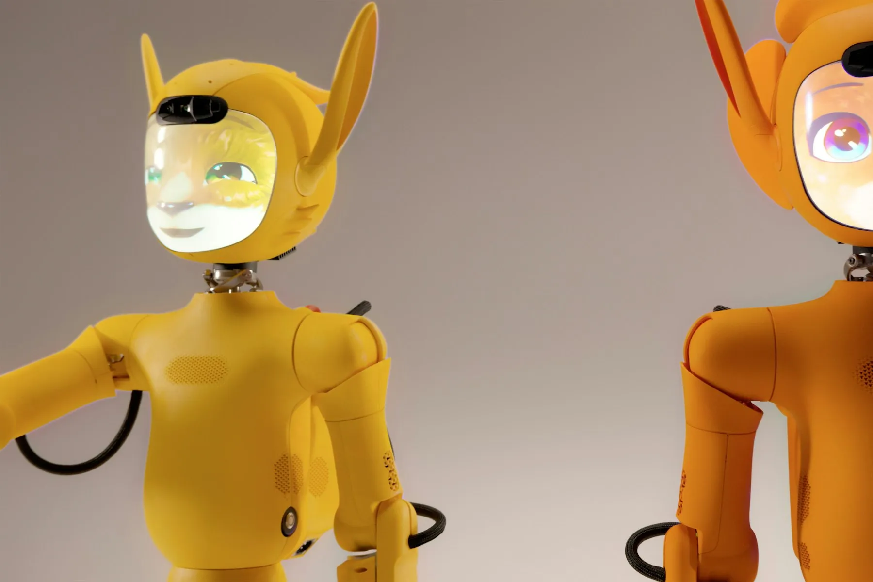 Two amber-coloured humanoid robots with glowing animated faces